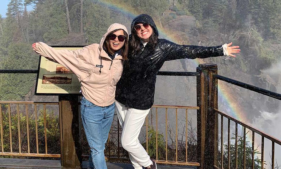 Xiulin Wang in front of waterfall with friend